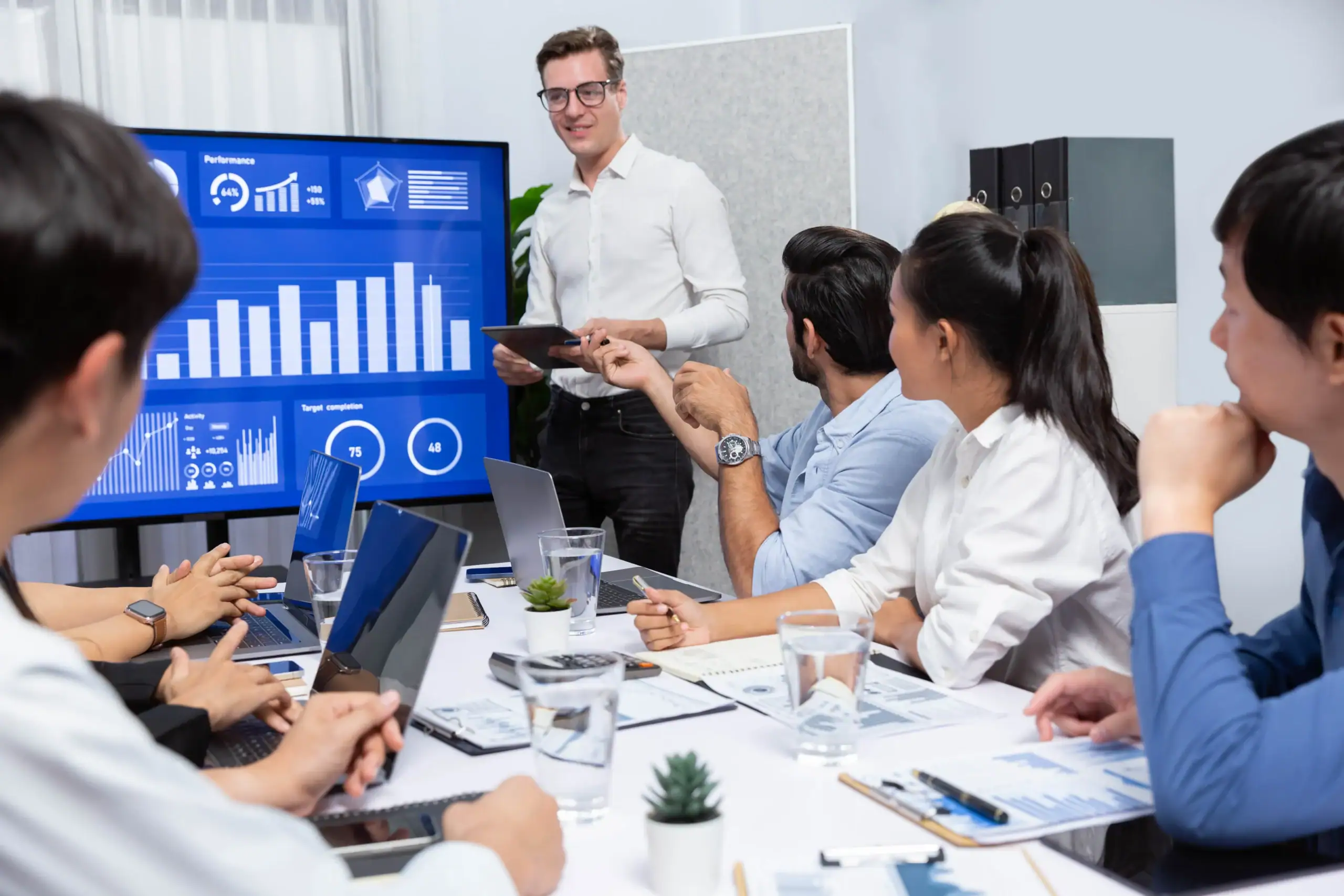 AI consulting professionals reviewing business analytics and technology solutions in Dallas, Texas through Peterson Technology Partners